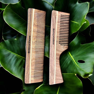 Sheesham wood combs pack of 2 on green leaves, natural hair care tool for healthy hair.