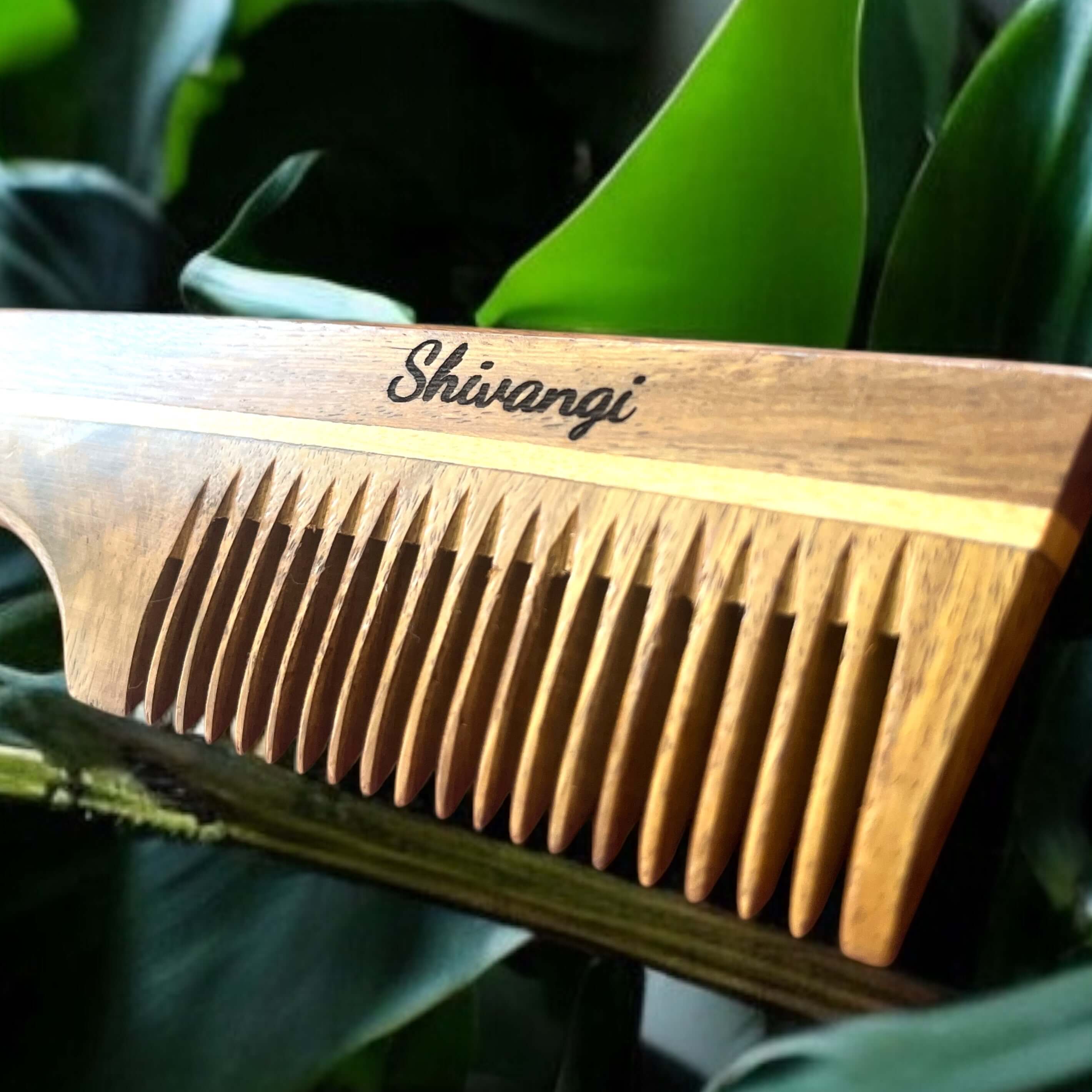 Sheesham wood comb with Shivangi engraving, showcasing natural craftsmanship and healthy hair benefits.